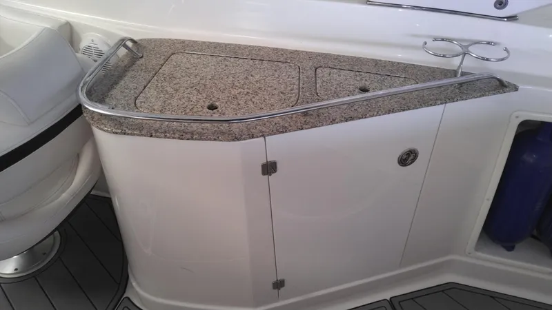 Slide: The Image of 2008 Monterey 254 FS boat interior with granite countertop and storage cabinet. - 15