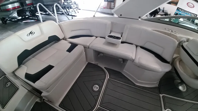Slide: The Image of 2008 Monterey 254 FS boat interior with white seating and cup holders. - 18