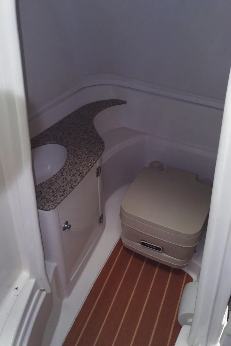 Slide: The Image of 2008 Monterey 254 FS boat bathroom with compact toilet and granite countertop. - 21