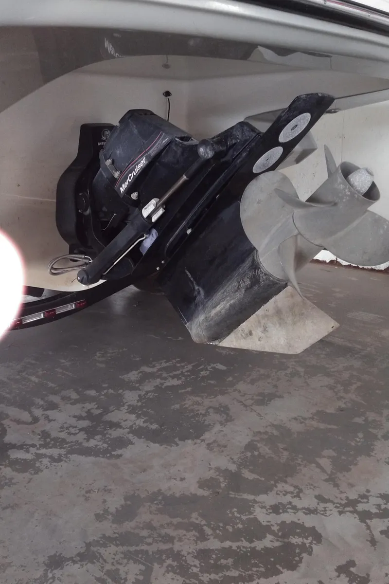 Slide: The Image of 2008 Monterey 254 FS boat propeller and drive system in a garage setting. - 26