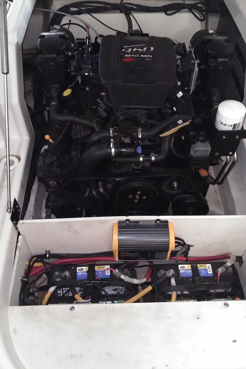 Slide: The Image of 2008 Monterey 254 FS engine compartment with batteries and wiring. - 28