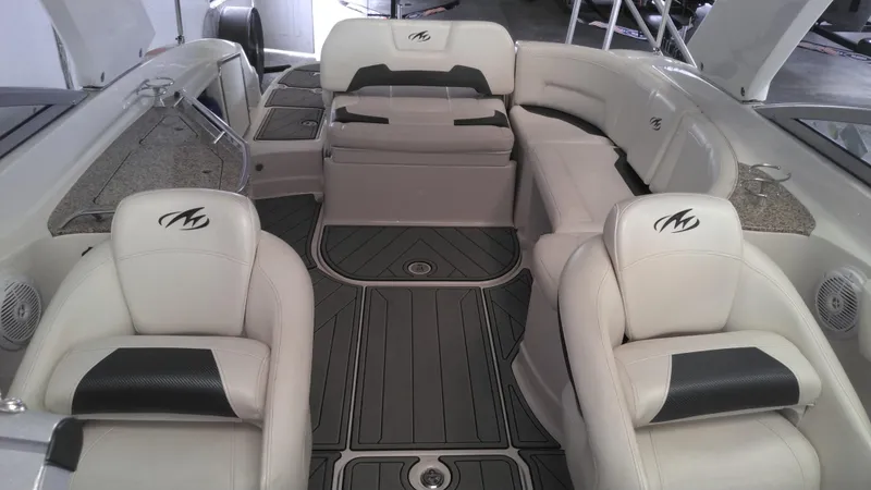 Slide: The Image of 2008 Monterey 254 FS boat interior with white seating and sleek design. - 5