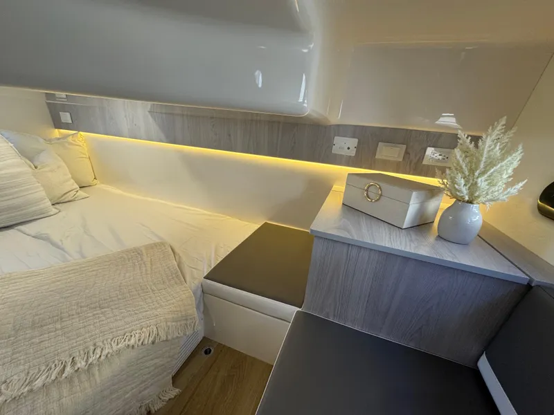 Slide: The Image of Modern interior of 2025 Hanover 387 RV with cozy bed and ambient lighting. - 10