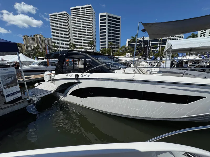 Slide: The Image of 2025 Hanover 387 yacht docked at marina, modern design, city skyline background. - 12