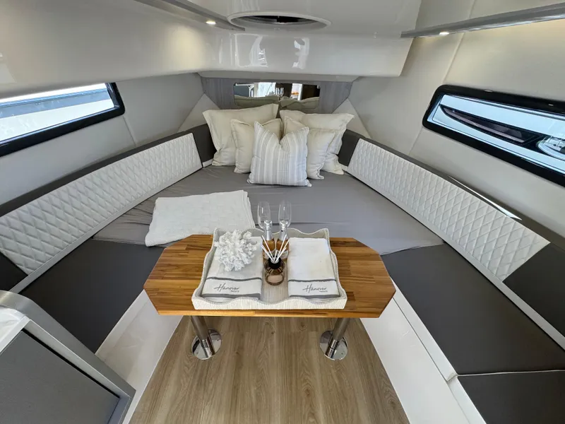 Slide: The Image of Luxurious interior of 2025 Hanover 387 yacht with elegant seating and dining setup. - 2