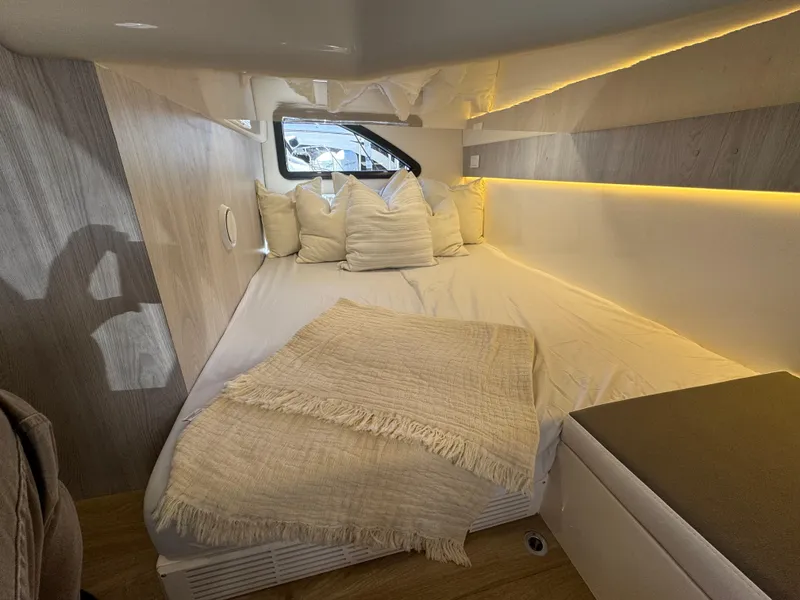 Slide: The Image of Luxurious cabin interior of 2025 Hanover 387 yacht with cozy bedding and ambient lighting. - 9
