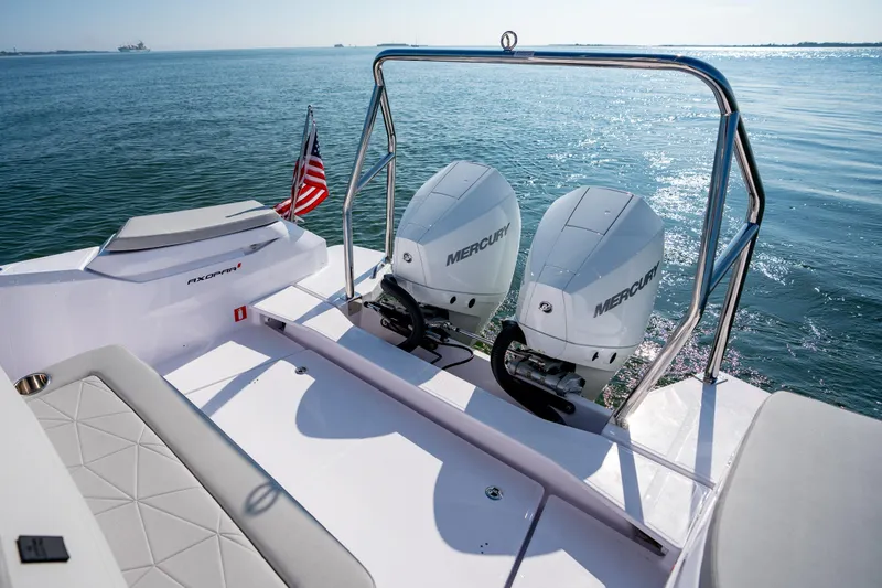 Slide: The Image of 2025 Axopar 29 Sun-Top boat with dual Mercury engines on open water. - 15