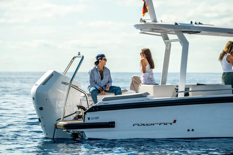 Slide: The Image of 2025 Axopar 29 Sun-Top boat interior with cushioned seating, ocean view. - 3