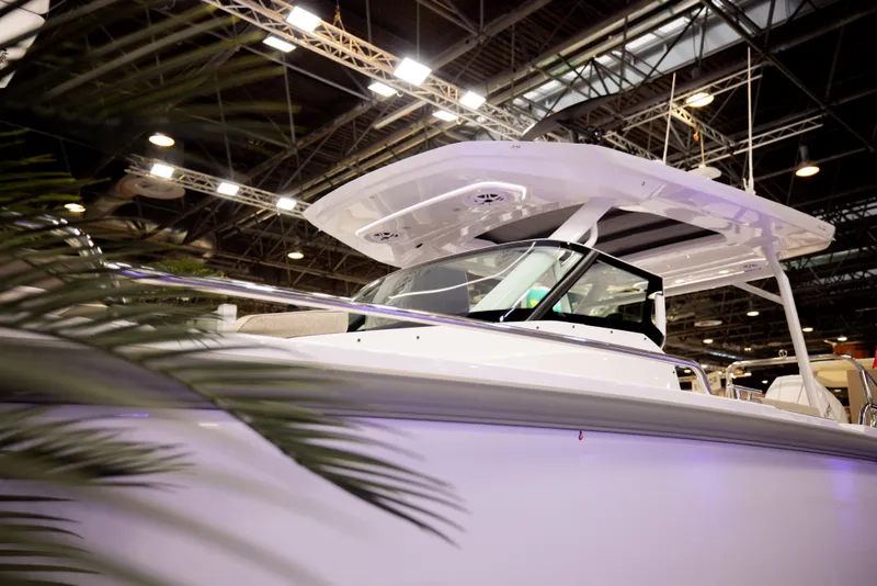 Slide: The Image of 2025 Axopar 29 Sun-Top boat on calm water, featuring sleek design and spacious deck. - 4