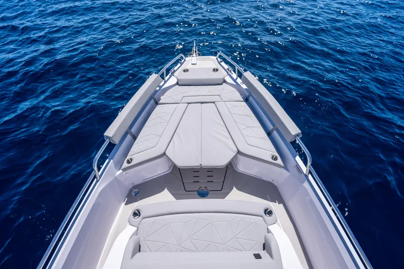 Slide: The Image of 2025 Axopar 29 Sun-Top cruising on open water, showcasing sleek design and comfortable seating. - 8