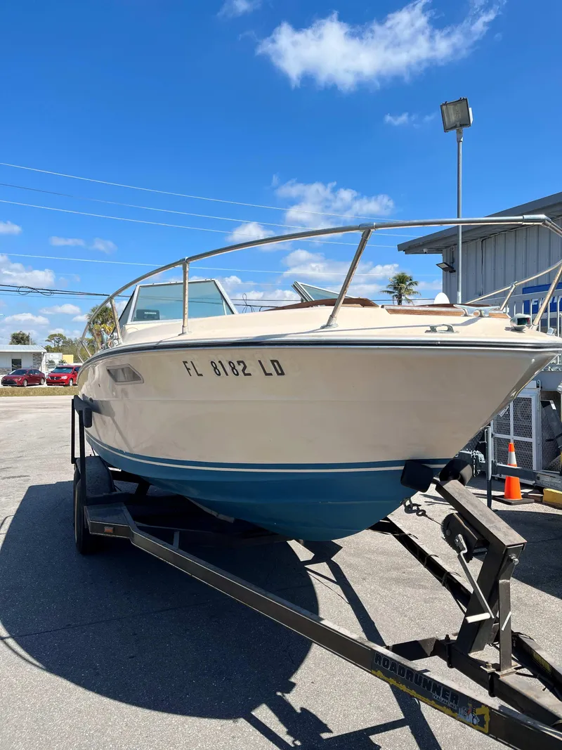 Slide: The Image of 1974 Sea Ray SRV 220 CC boat on trailer under clear blue sky. - 1