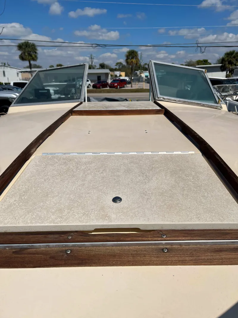 Slide: The Image of 1974 Sea Ray SRV 220 CC boat deck with windshield, under a clear blue sky. - 5