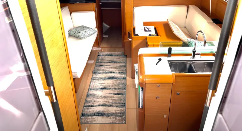 Slide: The Image of Interior of 2018 Jeanneau Sun Odyssey 419 yacht with modern kitchen and seating area. - 10