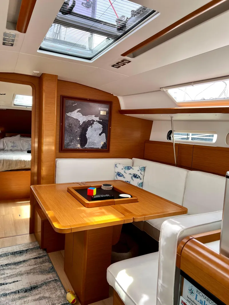 Slide: The Image of Interior of 2018 Jeanneau Sun Odyssey 419 sailboat with dining area and skylight. - 11