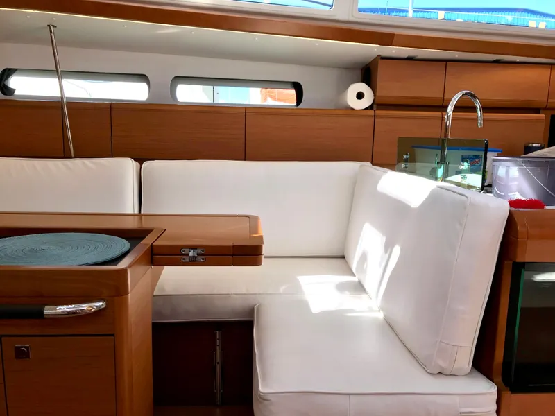 Slide: The Image of Interior of 2018 Jeanneau Sun Odyssey 419 yacht with white seating and wooden accents. - 14