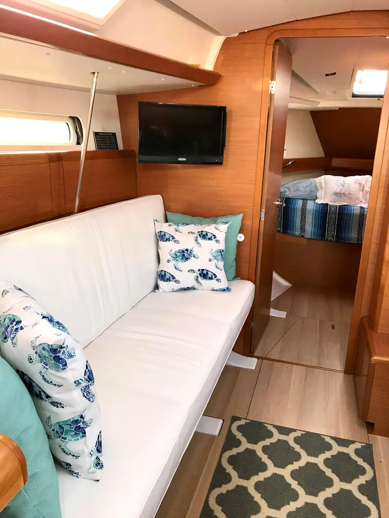 Slide: The Image of Interior of 2018 Jeanneau Sun Odyssey 419 yacht with cozy seating and nautical decor. - 15