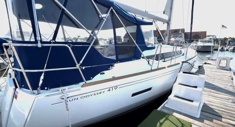 Slide: The Image of 2018 Jeanneau Sun Odyssey 419 sailboat docked at marina with blue canopy. - 5