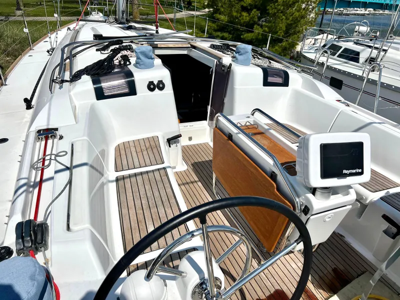 Slide: The Image of 2018 Jeanneau Sun Odyssey 419 sailboat cockpit with steering wheel and navigation equipment. - 7