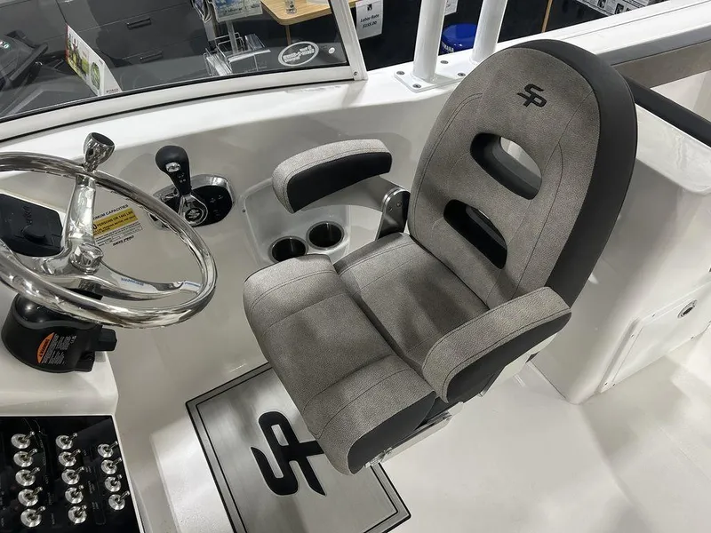 Slide: The Image of 2025 Sea Pro 240 Dual Console helm with cushioned captain's chair and steering wheel. - 11