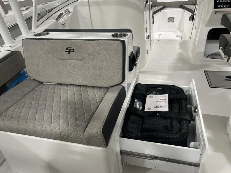 Slide: The Image of 2025 Sea Pro 240 Dual Console interior with storage drawer and seating. - 14