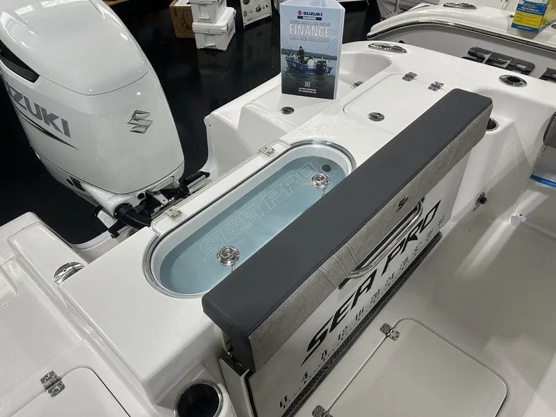 Slide: The Image of 2025 Sea Pro 240 Dual Console boat with Suzuki engine, featuring a livewell and seating area. - 17