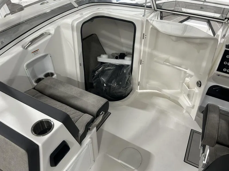 Slide: The Image of 2025 Sea Pro 240 Dual Console interior with seating and storage compartment. - 18