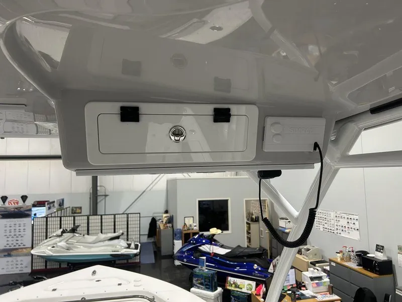 Slide: The Image of 2025 Sea Pro 240 Dual Console boat interior with storage compartment and equipment. - 19