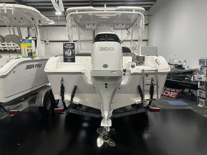 Slide: The Image of 2025 Sea Pro 240 Dual Console boat displayed indoors, rear view with outboard motor. - 3