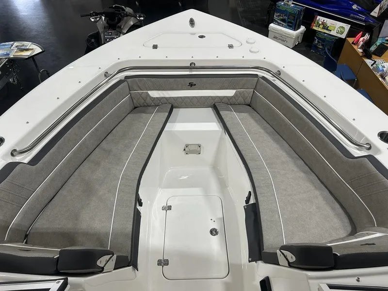 Slide: The Image of 2025 Sea Pro 240 Dual Console boat interior with gray seating and storage compartments. - 5