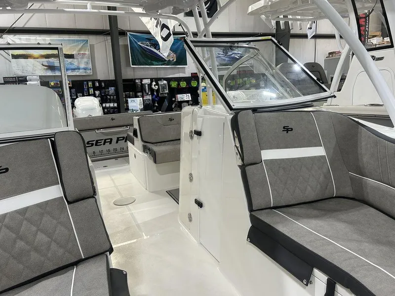 Slide: The Image of 2025 Sea Pro 240 Dual Console boat interior with gray seating and modern design. - 7