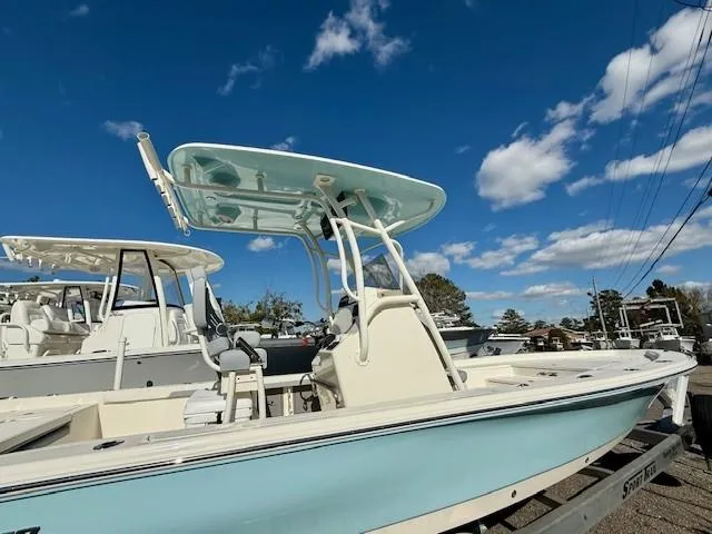 Slide: The Image of 2025 Avenger AV26 boat with T-top under a clear blue sky. - 1
