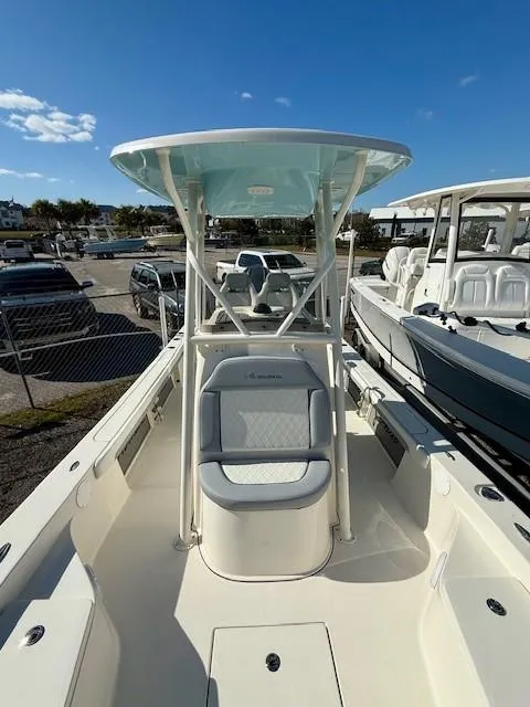 Slide: The Image of 2025 Avenger AV26 boat with center console, docked under clear blue sky. - 8