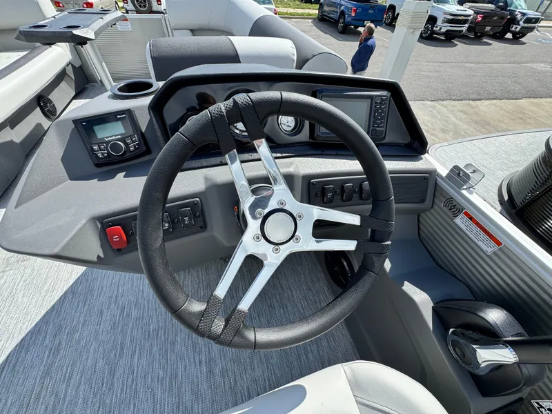 Slide: The Image of 2025 Bennington 22 SSB boat dashboard with steering wheel and control panel. - 11