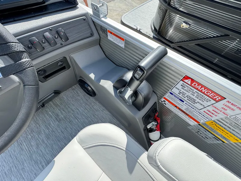 Slide: The Image of Interior view of 2025 Bennington 22 SSB boat cockpit with control panel and safety warnings. - 12