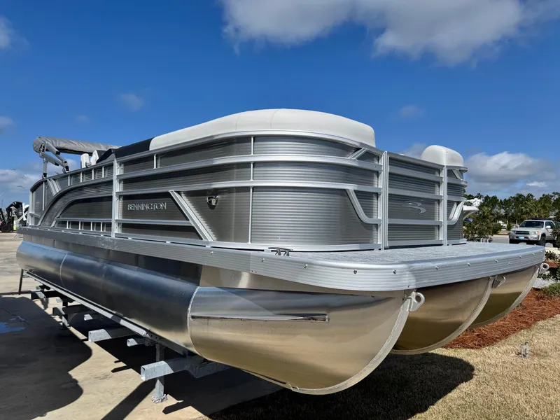 Slide: The Image of 2025 Bennington 22 SSB pontoon boat on display under a clear blue sky. - 3