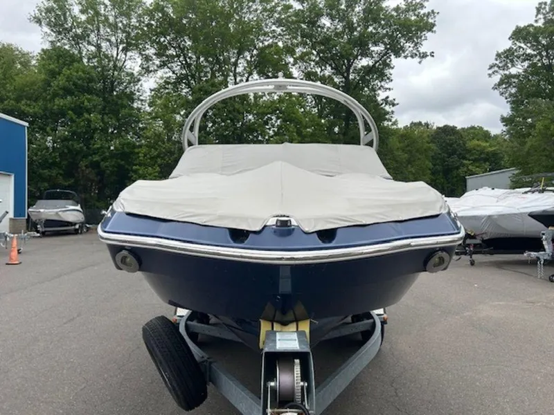 Slide: The Image of 2014 Yamaha 242 Limited S boat on trailer, covered, parked outdoors. - 11
