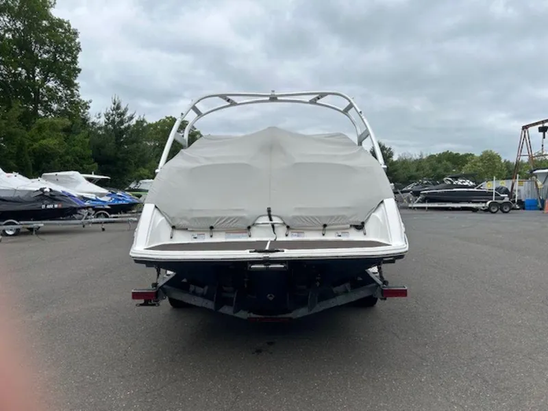 Slide: The Image of 2014 Yamaha 242 Limited S boat with galvanized trailer, covered and parked outdoors. - 12