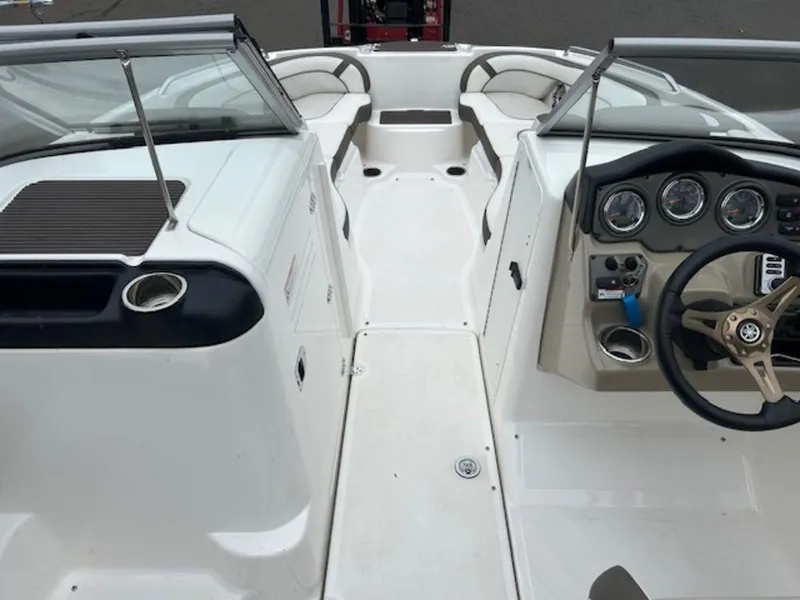 Slide: The Image of 2014 Yamaha Boats 242 Limited S interior with steering wheel and seating area. - 14