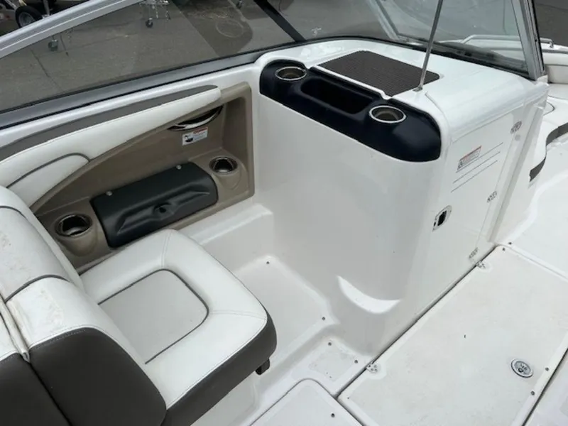 Slide: The Image of 2014 Yamaha Boats 242 Limited S interior, featuring white seating and cup holders. - 15