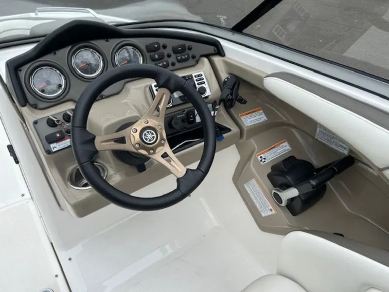 Slide: The Image of 2014 Yamaha Boats 242 Limited S dashboard with steering wheel and controls. - 16
