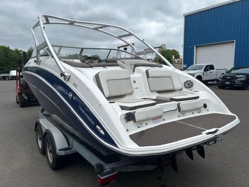 Slide: The Image of 2014 Yamaha Boats 242 Limited S on galvanized trailer, parked outdoors. - 3