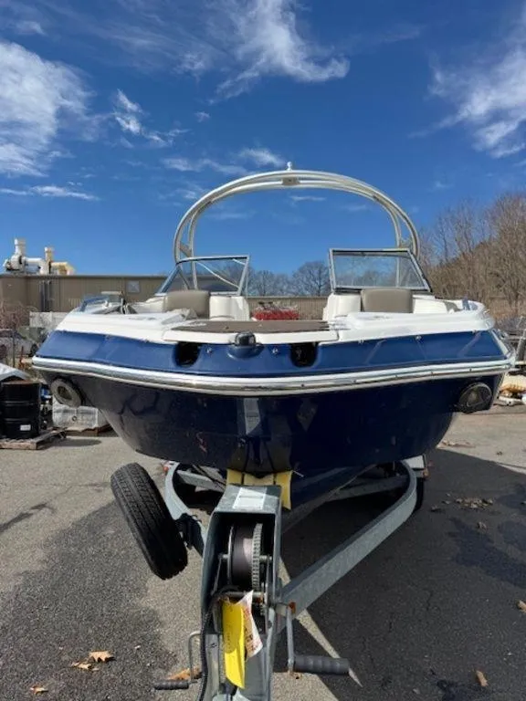 Slide: The Image of 2014 Yamaha Boats 242 Limited S on galvanized trailer, parked outdoors under blue sky. - 4