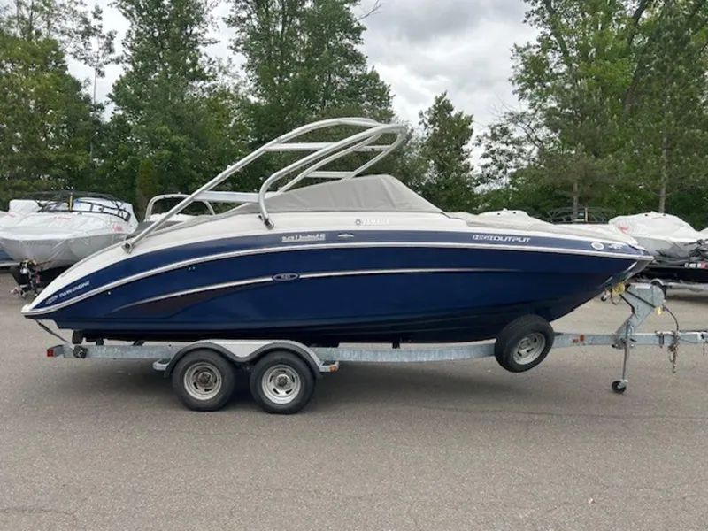Slide: The Image of 2014 Yamaha 242 Limited S boat on galvanized trailer, parked outdoors. - 7