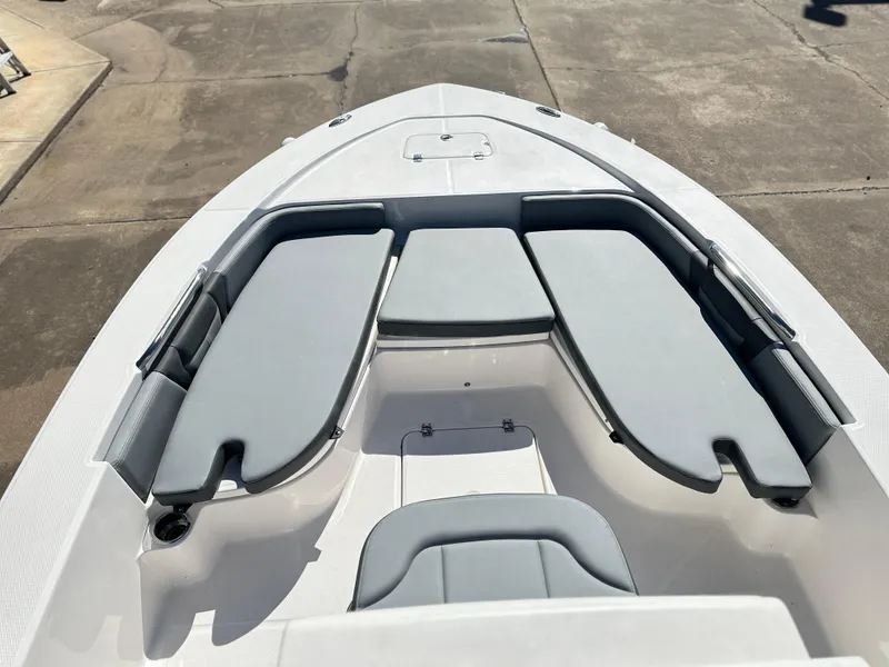 Slide: The Image of 2025 Robalo 226 Cayman boat interior with cushioned seating and storage compartments. - 5