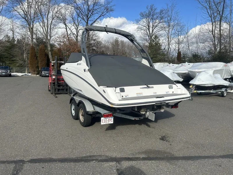 Slide: The Image of 2017 Yamaha Boats 212 Limited S on trailer, parked outdoors. - 14