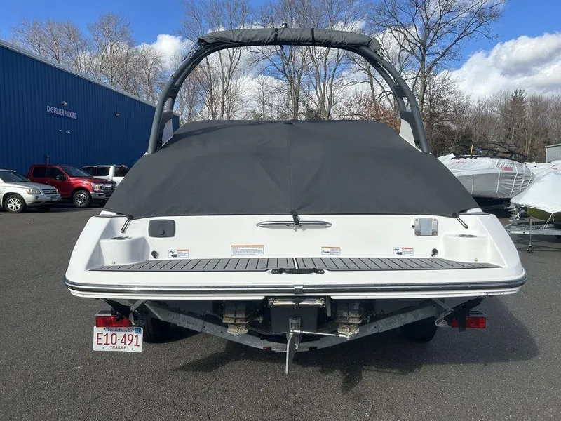 Slide: The Image of 2017 Yamaha Boats 212 Limited S, covered, parked outdoors, rear view. - 15