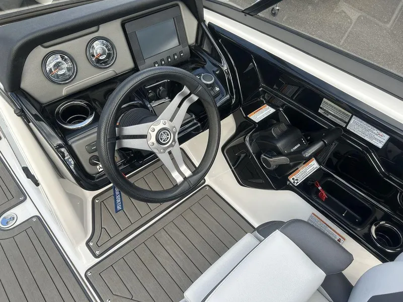 Slide: The Image of 2017 Yamaha Boats 212 Limited S dashboard with steering wheel and controls. - 6