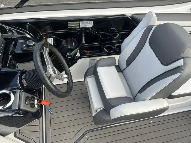 Slide: The Image of 2017 Yamaha Boats 212 Limited S cockpit with steering wheel and cushioned seat. - 8