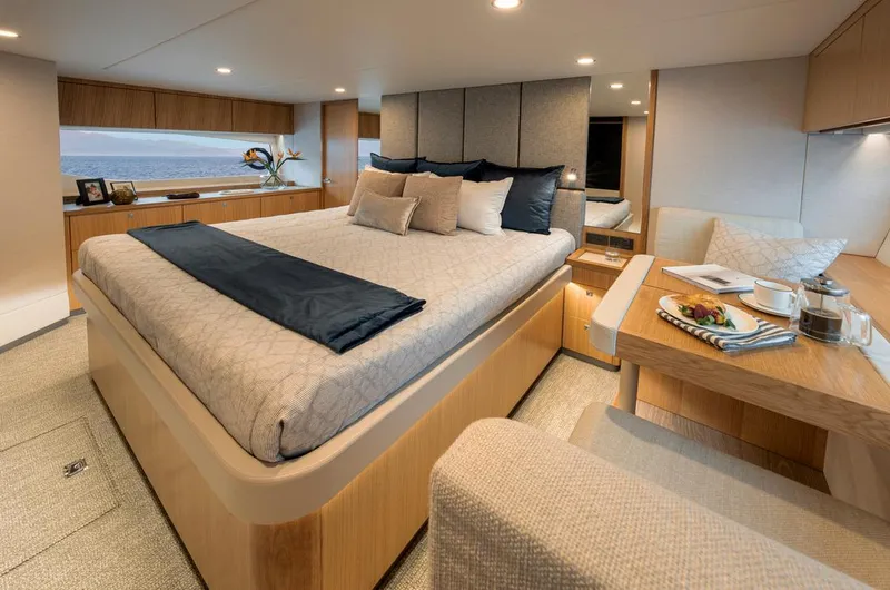 Slide: The Image of 2026 Riviera 58 Sports Motor Yacht cruising in a marina, surrounded by other boats. - 10