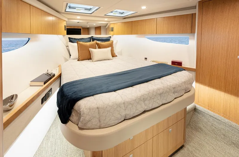 Slide: The Image of 2026 Riviera 58 Sports Motor Yacht with spacious deck and luxurious seating on water. - 12